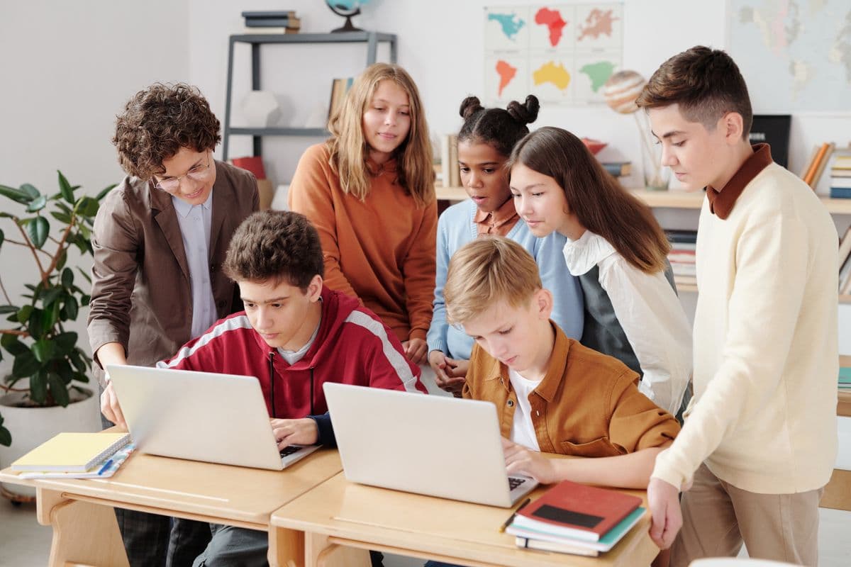 Students using digital learning platform in school ICT lab